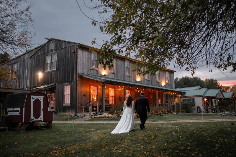 The outside of the venue at dusk with couple strolling in front.  Photo: Natalie Wagner Photography